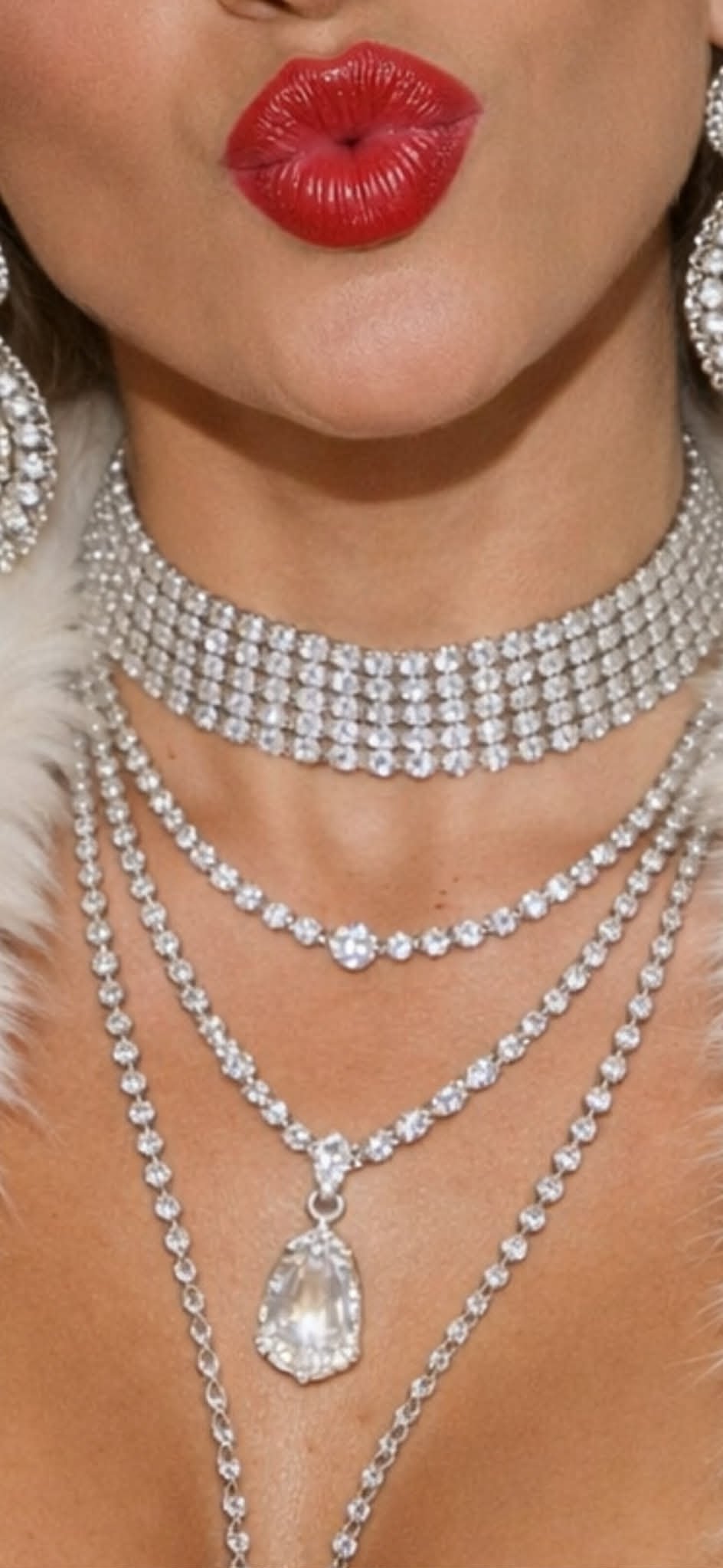 Close detail of Danielle's red lip and diamond necklaces.